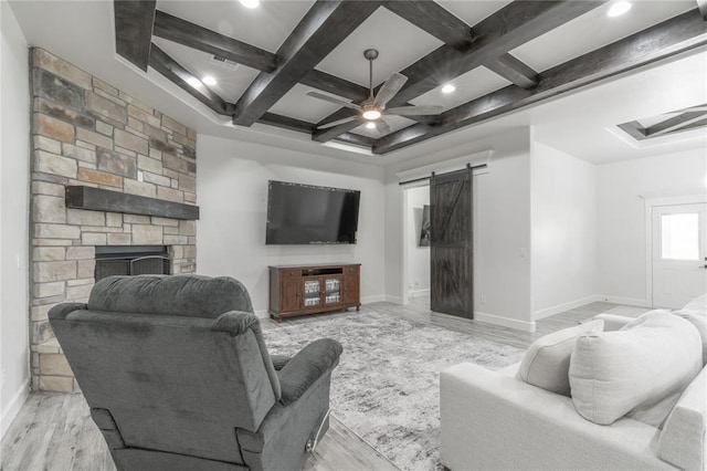 8908 NW 130th St, Oklahoma City, OK 73142 - living room with a barn door, coffered ceiling, ceiling fan, light wood finished floors, and beamed ceiling