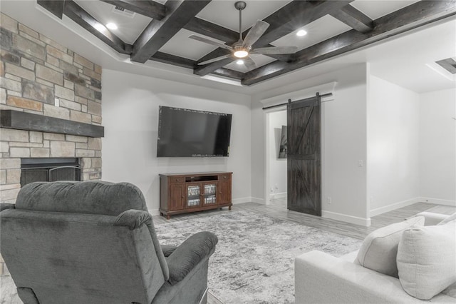 8908 NW 130th St, Oklahoma City, OK 73142 - living area with coffered ceiling, a barn door, beam ceiling, a ceiling fan, and wood finished floors