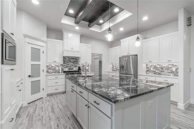 8908 NW 130th St, Oklahoma City, OK 73142 - kitchen with appliances with stainless steel finishes, a tray ceiling, light wood-type flooring, decorative backsplash, and recessed lighting