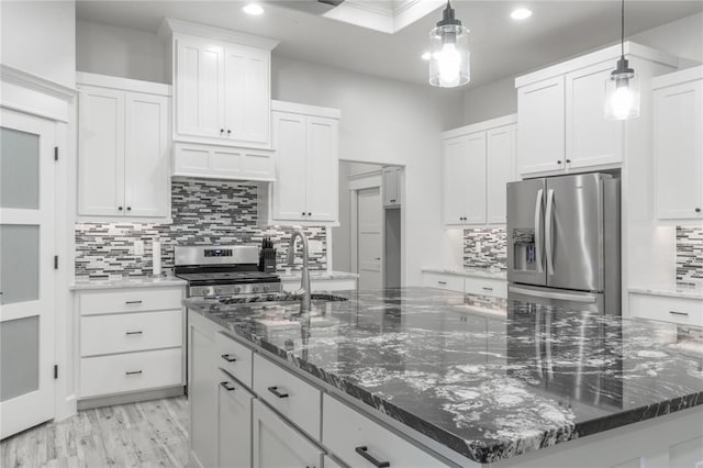 8908 NW 130th St, Oklahoma City, OK 73142 - kitchen with appliances with stainless steel finishes, a large island, recessed lighting, tasteful backsplash, and white cabinets