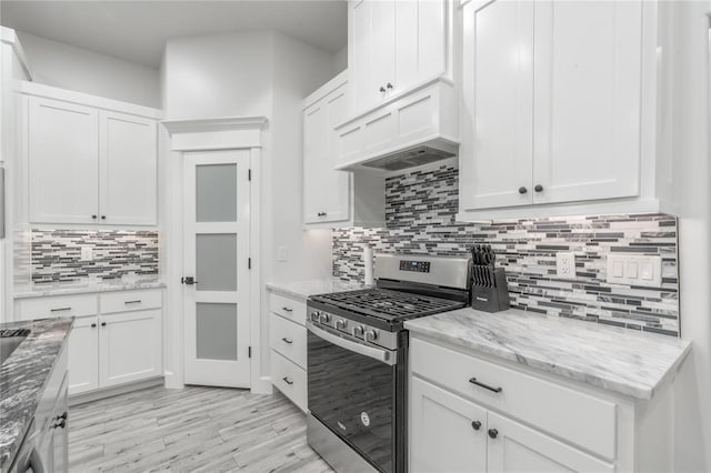 8908 NW 130th St, Oklahoma City, OK 73142 - kitchen featuring gas range, backsplash, and white cabinetry