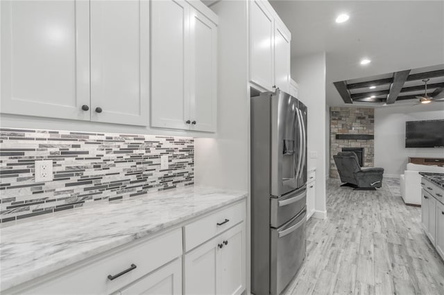 8908 NW 130th St, Oklahoma City, OK 73142 - kitchen with stainless steel fridge, open floor plan, recessed lighting, light wood-style floors, and tasteful backsplash