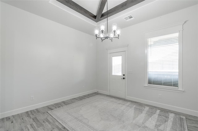 8908 NW 130th St, Oklahoma City, OK 73142 - empty room featuring a chandelier, wood finished floors, and beamed ceiling