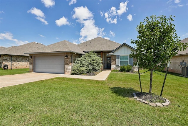 4213 NW 155th St, Edmond, OK 73013 - view of front of house featuring an attached garage, a front yard, driveway, and brick siding