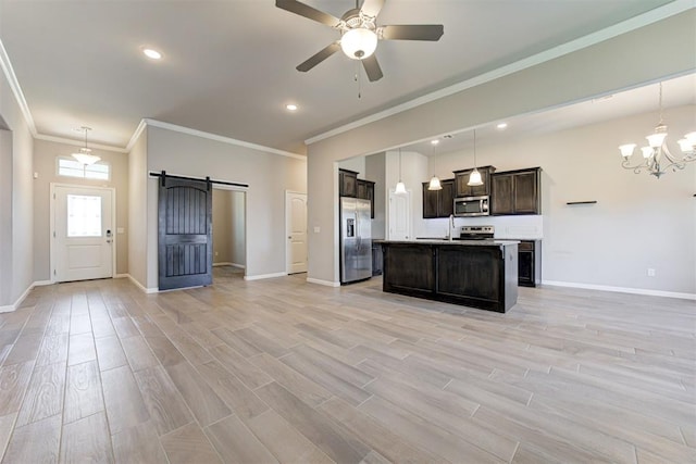 4213 NW 155th St, Edmond, OK 73013 - kitchen with stainless steel appliances, a barn door, open floor plan, dark brown cabinetry, and light wood-style flooring