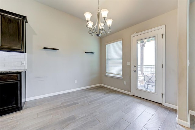 4213 NW 155th St, Edmond, OK 73013 - unfurnished dining area featuring light wood-type flooring, a chandelier, and a fireplace