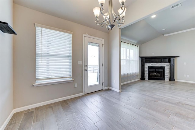 4213 NW 155th St, Edmond, OK 73013 - unfurnished living room with a chandelier, light wood finished floors, vaulted ceiling, and a fireplace