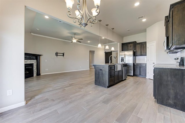 4213 NW 155th St, Edmond, OK 73013 - kitchen featuring open floor plan, ceiling fan, appliances with stainless steel finishes, dark brown cabinets, and a chandelier