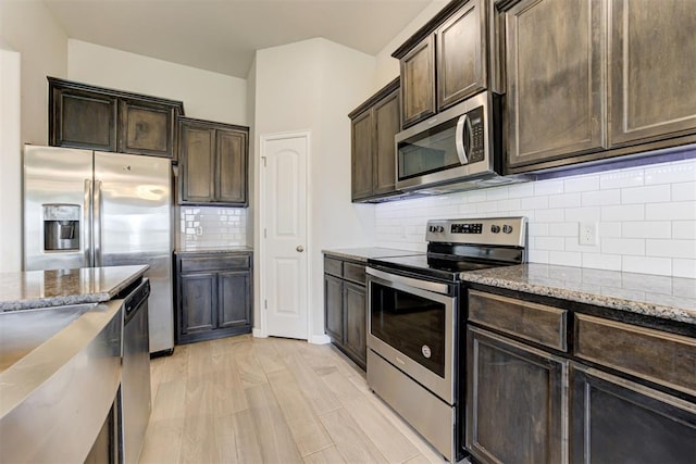 4213 NW 155th St, Edmond, OK 73013 - kitchen featuring appliances with stainless steel finishes, stone countertops, and dark brown cabinets