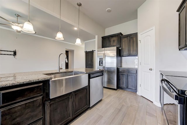 4213 NW 155th St, Edmond, OK 73013 - kitchen featuring appliances with stainless steel finishes, light stone counters, ceiling fan, decorative light fixtures, and ornamental molding