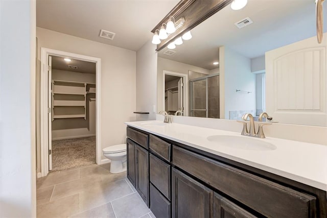 4213 NW 155th St, Edmond, OK 73013 - bathroom featuring a spacious closet, double vanity, tile patterned flooring, and a shower stall