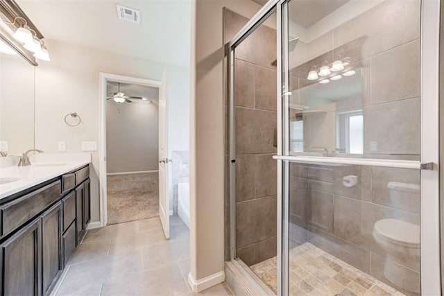 4213 NW 155th St, Edmond, OK 73013 - bathroom with double vanity, a ceiling fan, a stall shower, and tile patterned floors