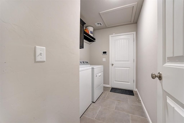 4213 NW 155th St, Edmond, OK 73013 - laundry area with washing machine and dryer and light tile patterned floors