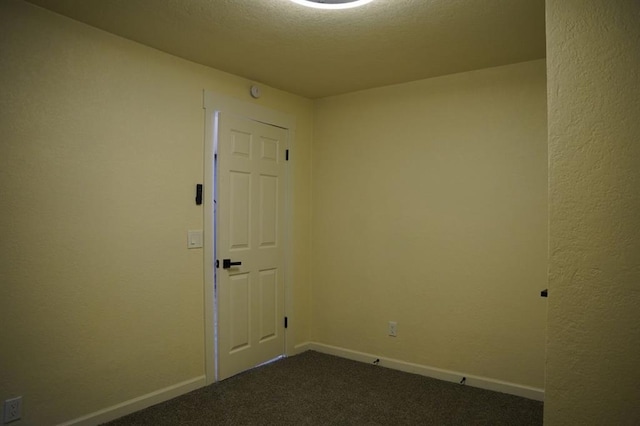 3309 SW 27th St, Oklahoma City, OK 73108 - spare room featuring dark carpet and baseboards