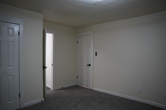 3309 SW 27th St, Oklahoma City, OK 73108 - spare room featuring dark colored carpet and a textured ceiling