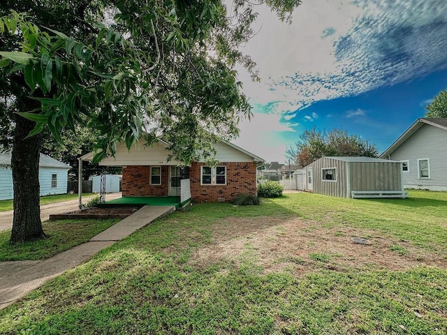 309 N Spencer Ave, Hinton, OK 73047 - view of front of house featuring brick siding and an outdoor structure