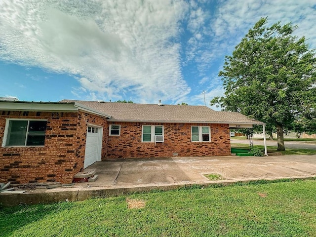 309 N Spencer Ave, Hinton, OK 73047 - back of house with an attached garage, a lawn, and brick siding