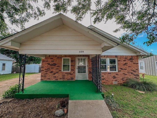 309 N Spencer Ave, Hinton, OK 73047 - bungalow with brick siding and crawl space