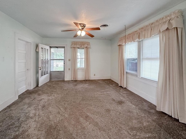 309 N Spencer Ave, Hinton, OK 73047 - spare room featuring ceiling fan and carpet floors