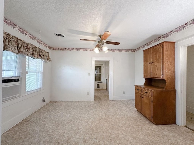309 N Spencer Ave, Hinton, OK 73047 - unfurnished room with a textured ceiling, ceiling fan, cooling unit, and light colored carpet