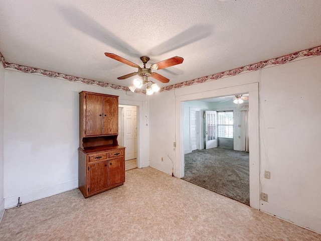 309 N Spencer Ave, Hinton, OK 73047 - empty room with ceiling fan, light carpet, and a textured ceiling