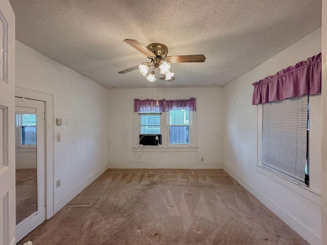 309 N Spencer Ave, Hinton, OK 73047 - unfurnished room featuring carpet flooring, ceiling fan, plenty of natural light, a textured ceiling, and cooling unit