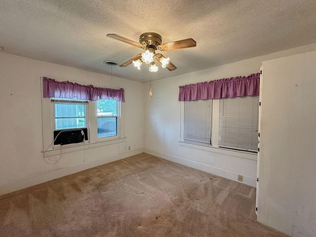 309 N Spencer Ave, Hinton, OK 73047 - carpeted spare room with a ceiling fan, a textured ceiling, and cooling unit