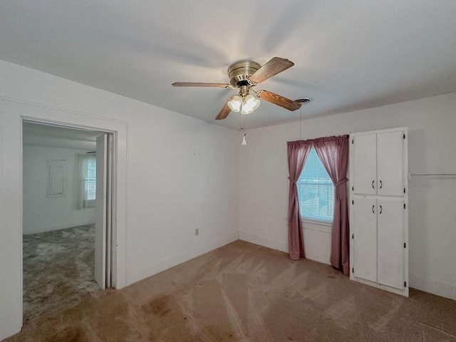 309 N Spencer Ave, Hinton, OK 73047 - unfurnished room with light colored carpet, plenty of natural light, and a ceiling fan