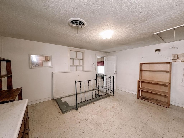 309 N Spencer Ave, Hinton, OK 73047 - basement featuring a textured ceiling and tile patterned floors