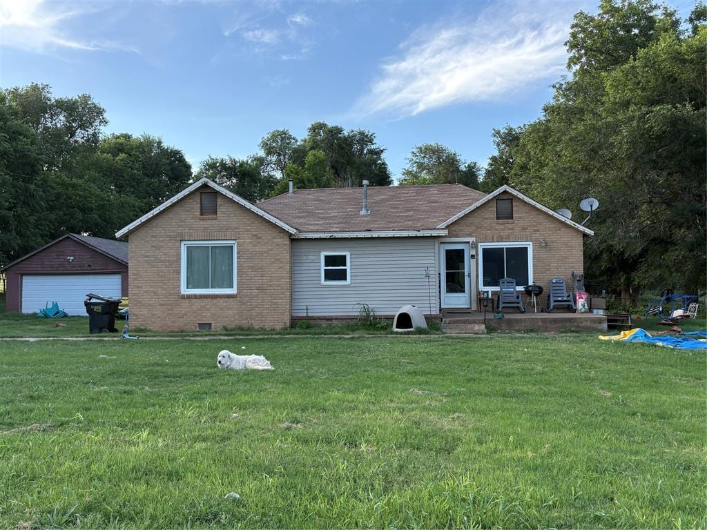 1218 County Road 1230, Tuttle, OK 73089 - back of house featuring a yard, a patio area, and brick siding