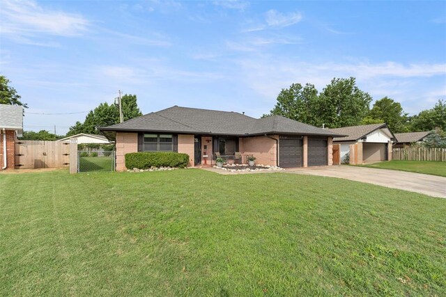 8316 NW 39th St, Bethany, OK 73008 - view of front of house with brick siding, a garage, concrete driveway, and a gate
