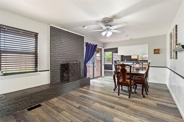 8316 NW 39th St, Bethany, OK 73008 - dining space with a ceiling fan, a brick fireplace, and wood finished floors