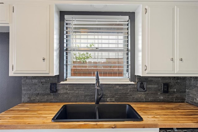 8316 NW 39th St, Bethany, OK 73008 - kitchen with butcher block countertops, tasteful backsplash, and white cabinetry