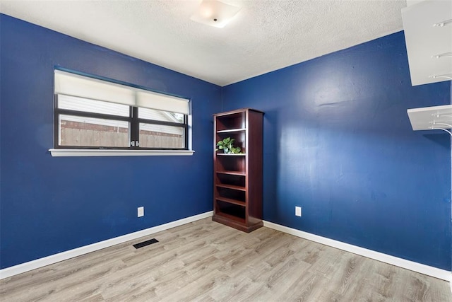 8316 NW 39th St, Bethany, OK 73008 - unfurnished room featuring wood finished floors and a textured ceiling