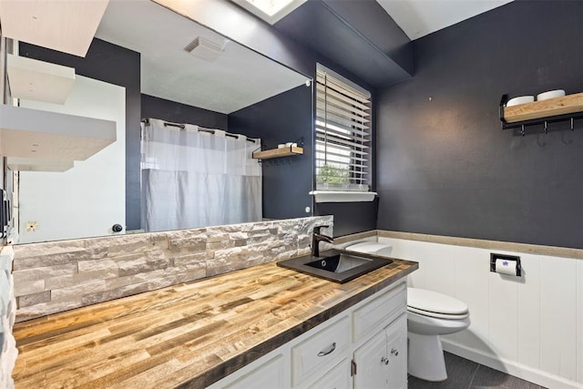 8316 NW 39th St, Bethany, OK 73008 - bathroom with vanity, curtained shower, and wainscoting