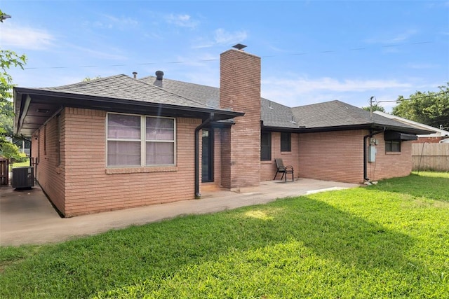 8316 NW 39th St, Bethany, OK 73008 - back of property with a patio, a chimney, a shingled roof, and brick siding
