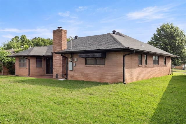 8316 NW 39th St, Bethany, OK 73008 - rear view of house featuring a chimney, a lawn, brick siding, and a shingled roof