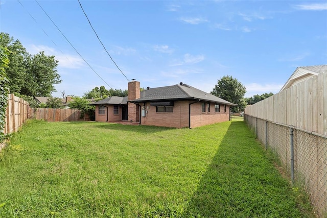 8316 NW 39th St, Bethany, OK 73008 - rear view of property with a fenced backyard, a chimney, brick siding, and roof with shingles