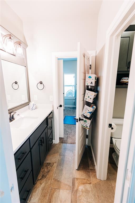 11501 SW 56th St, Mustang, OK 73064 - bathroom with vanity and stone finish floors