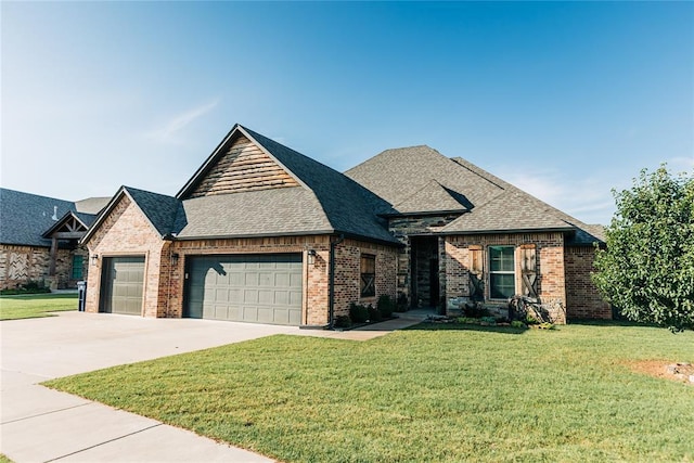 11501 SW 56th St, Mustang, OK 73064 - french country home featuring an attached garage, brick siding, a front lawn, and roof with shingles