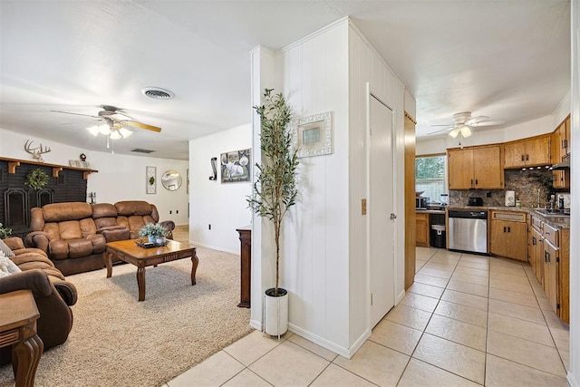 213 Meadowlark Ln, Fort Cobb, OK 73038 - living area featuring ceiling fan, light tile patterned floors, and light carpet