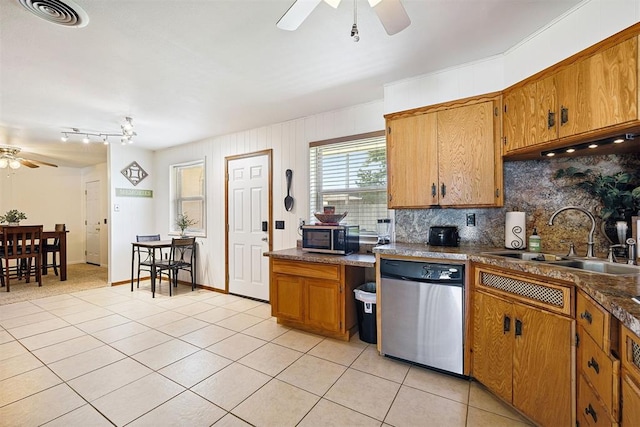 213 Meadowlark Ln, Fort Cobb, OK 73038 - kitchen with a ceiling fan, stainless steel appliances, brown cabinets, and decorative backsplash