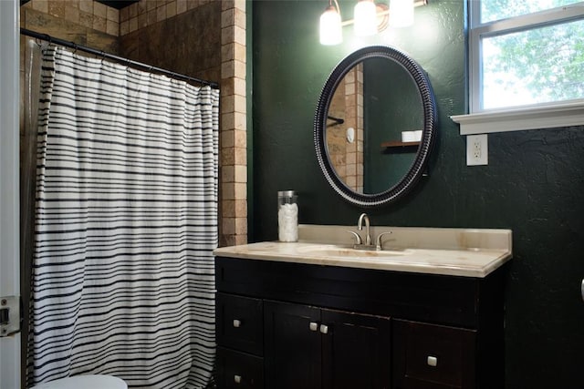 2629 Cashion Pl, Oklahoma City, OK 73112 - bathroom featuring a textured wall, vanity, and a shower with shower curtain