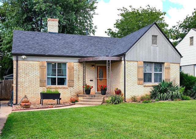 2629 Cashion Pl, Oklahoma City, OK 73112 - view of front of home featuring brick siding, a chimney, roof with shingles, and board and batten siding