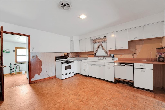 105 E E Walk, Canute, OK 73626 - kitchen with white appliances, white cabinetry, light countertops, and light floors