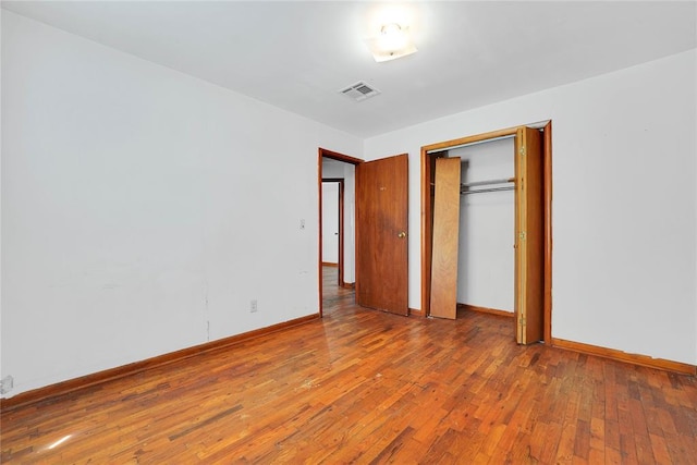 105 E E Walk, Canute, OK 73626 - unfurnished bedroom featuring hardwood / wood-style floors and a closet