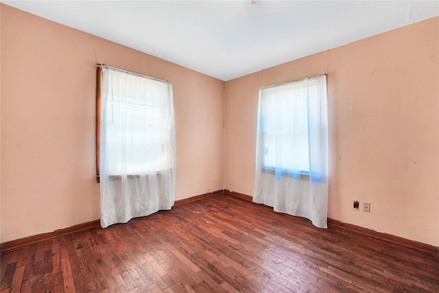 105 E E Walk, Canute, OK 73626 - unfurnished room featuring hardwood / wood-style flooring and healthy amount of natural light