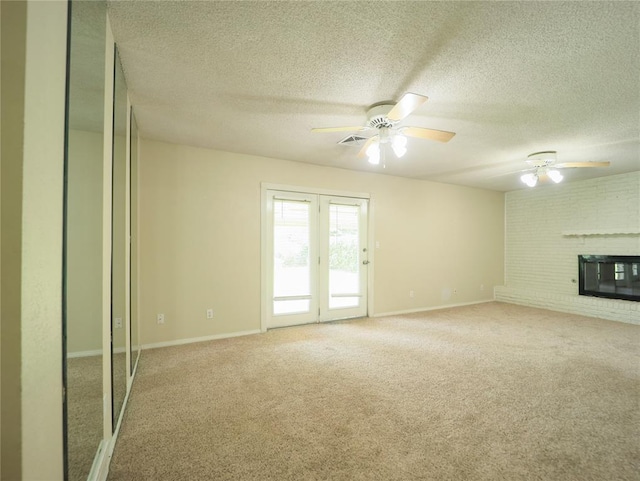 516 SW 63rd Ter, Oklahoma City, OK 73139 - unfurnished living room with ceiling fan, a textured ceiling, light carpet, and a fireplace