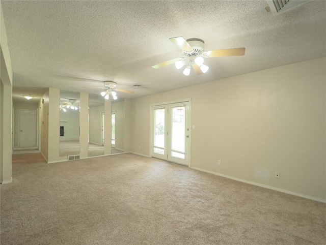 516 SW 63rd Ter, Oklahoma City, OK 73139 - spare room with a ceiling fan, a textured ceiling, and light colored carpet