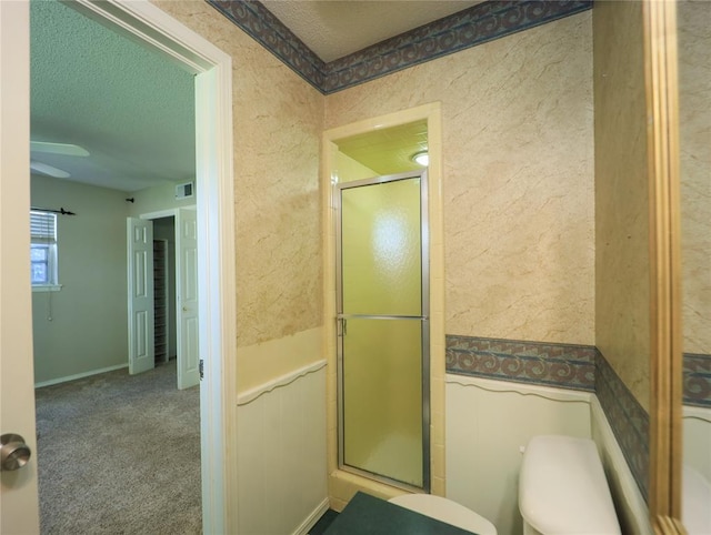 516 SW 63rd Ter, Oklahoma City, OK 73139 - full bathroom with a stall shower, a textured ceiling, and wainscoting